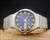 Close-up of the Osman blue dial, showing the rare indexes, automatic signature, hands, minute track and day-date calendar.