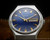 Front view of the Osman automatic watch, with blue dial, rare applied indexes, luminous hands and framed day-date display.