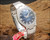 Angled view of the Osman 982 NOS automatic watch on wood, highlighting the faceted Plexiglas crystal, blue dial, stainless steel case and original bracelet.