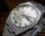 Close-up view of the Osman 982 automatic dial, showing the silver finish, raised hour indexes, day-date calendar and faceted crystal.