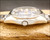 Crown-side profile of the Osman-Clipper LH-1004 NOS automatic, showing the stainless steel case, original crown, faceted Plexiglas crystal and bracelet connection.