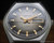 Front view of the Osman mechanical watch, with brown fumé dial, raised gold-tone indexes, gold-tone hands and Spanish day-date display.