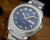NOS Osman vintage automatic watch in stainless steel, with two-tone blue dial, Spanish day-date calendar, raised silver-tone indexes and original steel bracelet.