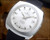 NOS Osman automatic vintage watch in stainless steel, with silver sunburst dial, raised silver-tone indexes, date window and genuine black leather strap.