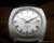 Front view of the Osman automatic watch, with silver sunburst dial, raised silver-tone indexes, silver-tone hands and date window at 3.