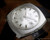 Close-up view of the Osman automatic dial, showing the silver sunburst finish, applied hour indexes, date display and clean vintage 1970s design.