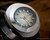 Angled close-up of the Voga green fumé dial, highlighting the raised silver-tone indexes, red seconds hand and framed day-date window.