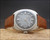 Front display of the Stelwatch NOS automatic watch, showing the stainless steel case, smoky grey dial layout, date window and brown Italian leather strap.