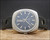 Front display of the Titan Submerger NOS automatic watch, showing the stainless steel cushion case, blue-grey dial layout, aged luminous dots and day-date window.
