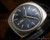Close-up view of the Titan Submerger automatic dial, showing the blue-grey finish, applied hour indexes, visible age around the luminous dots and Submerger signature.