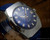 Angled close-up of the Tecnal navy blue dial, showing the applied silver-tone indexes, white painted details, red seconds hand and framed date window.