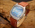 NOS Tecnal automatic vintage watch with perfect blue dial, 30-rubis marking, date window, cushion-shaped 1970s case and brown vintage-style strap.