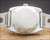 Caseback view of the Tecnal automatic watch, showing the stainless steel back, original crown and vintage stainless steel bracelet.