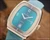 NOS Tecnal automatic vintage watch with turquoise two-tone dial, 22-rubis marking, date window, square 1970s case and brand new turquoise strap.