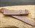Original Aureole strap included for collecting, shown with its original vintage condition and gold-tone buckle.