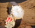 Angled view of the Aureole automatic vintage watch on wood, highlighting the 20 microns gold-plated case, silver dial, date magnifier and original tags.