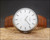 Vintage Tissot Stylist watch displayed on natural wood, featuring its stainless steel case, silver dial and new brown crocodile-pattern Italian leather strap.