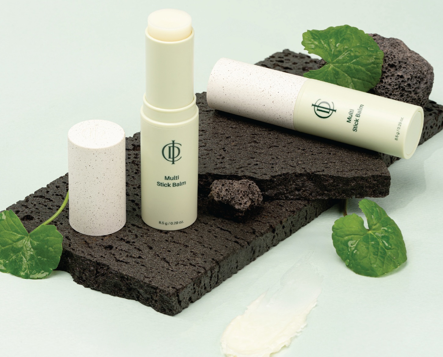 ICD Multi Stick Balm lifestyle on volcanic rock with byungpool leaves