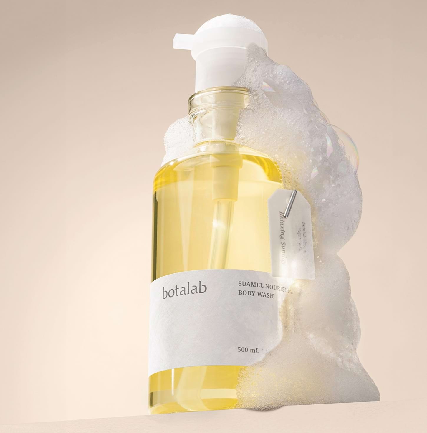 Suamel Nourishing Body Wash lifestyle with foam around the bottle