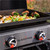 Blackstone Griddle 2205 Omnivore Original; Uses H Style Burner For Even Heating; Table Top; Two Independent Heat Zones With 21 000 BTU; 22 Inch Cooking Space; Rectangular; Stainless Steel Front Panel; With Hood