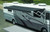 Carefree RV Awning IY2010JV Springless; Patio Awning; Electric; 20 Foot Length x 8 Foot Extension; Cadet Gray; Solid Acrylic; Black Alumaguard; Adjustable Pitch; Required Arms Must Be Purchased Separately
