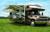 Carefree RV Awning IY2010JV Springless; Patio Awning; Electric; 20 Foot Length x 8 Foot Extension; Cadet Gray; Solid Acrylic; Black Alumaguard; Adjustable Pitch; Required Arms Must Be Purchased Separately