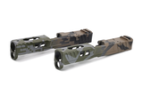 A Norsso glock 19 slide finished in Chromatic Storm pattern, featuring a chromatic fade base layered beneath a precision camo overlay with black and tan transitional fades.