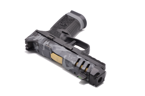 Close-up angled view of the FN 509 CC Edge XL custom Cerakote slide featuring Gotham Camo, revealing multiple shades of graphite, charcoal, and tungsten gray. High-detail image emphasizes the texture, depth, and precision masking of the custom Cerakote application.