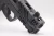 Macro close-up of the Smith & Wesson M&P 2.0 Carry Comp Performance Center highlighting the integrated compensator, precision-machined front slide serrations, optics-ready slide cut, and premium factory machining on a clean white backdrop.