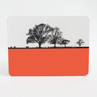 Tree silhouette melamine tablemat by Jacky Al-Samarraie with orange block colour. 