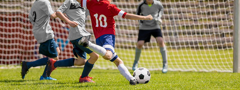 How to Fundraise - Soccer Game With Soccer Player Ready to Score Goal for VFW Fundraising Ideas & Marching Band Fundraiser Ideas