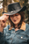 Biker wearing Buffalo Nickel Distressed Brown Leather Cowboy Hat outdoors – showcasing rugged western style during a motorcycle ride Biker wearing Buffalo Nickel Distressed Brown Leather Cowboy Hat outdoors – showcasing rugged western style during a motorcycle ride
