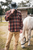 Person wearing Buffalo Nickel Distressed Brown Leather Cowboy Hat – demonstrating western style and durability during outdoor activity Person wearing Buffalo Nickel Distressed Brown Leather Cowboy Hat – demonstrating western style and durability during outdoor activity