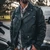Man wearing UNIK Brando black leather motorcycle jacket, showcasing its classic biker silhouette