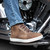 Close-up view of brown leather motorcycle riding sneakers with cushioned sole