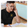 Man wearing Officially Licensed US Army Veteran Flag Polo on black polo shirt with yellow embroidery working at desk