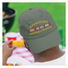 man wearing Operation Enduring Freedom Embroidered Black Hat with Service Ribbon on backwards while eating corn at a bbq