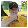 man wearing Officially Licensed by the U.S. Air Force Black 6 Panel Hat with USAF Vietnam Veteran Patch sitting on park bench