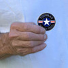 man holding us air force veteran challenge coin roundel logo