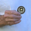 man holding us army veteran challenge coin eagle