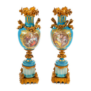A Fine Quality Pair of Sèvres Style Ormolu Mounted Porcelain Urns with Cherubs A Fine Quality Pair of Sèvres Style Ormolu Mounted Porcelain Urns with Cherubs