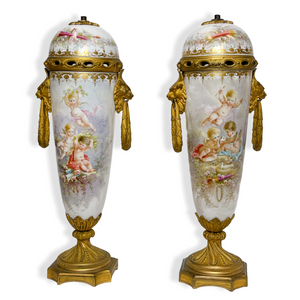 Pair of Sèvres porcelain Urns Hand painted with Putti and Classical Instruments Pair of Sèvres porcelain Urns Hand painted with Putti and Classical Instruments