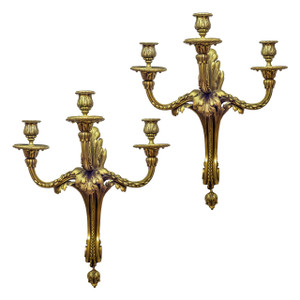 Pair of Caldwell gilt bronze three light sconces, featuring an acanthus leaf design. Pair of Caldwell gilt bronze three light sconces, featuring an acanthus leaf design.