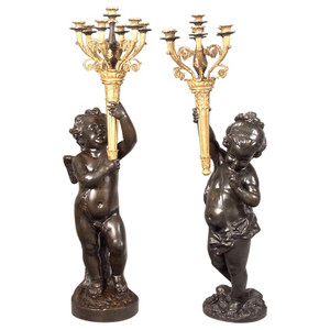 A Pair of Important Gilt and Patinated Bronze Putti Torchères A Pair of Important Gilt and Patinated Bronze Putti Torchères