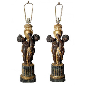 Edward F Caldwell A fine pair of gilt bronze lamps, in the form of Putti Holding Urns  Edward F Caldwell A fine pair of gilt bronze lamps, in the form of Putti Holding Urns