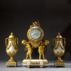 French Ormolu and White Marble Three-Piece Clock Set French Ormolu and White Marble Three-Piece Clock Set