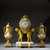 French Ormolu and White Marble Three-Piece Clock Set French Ormolu and White Marble Three-Piece Clock Set