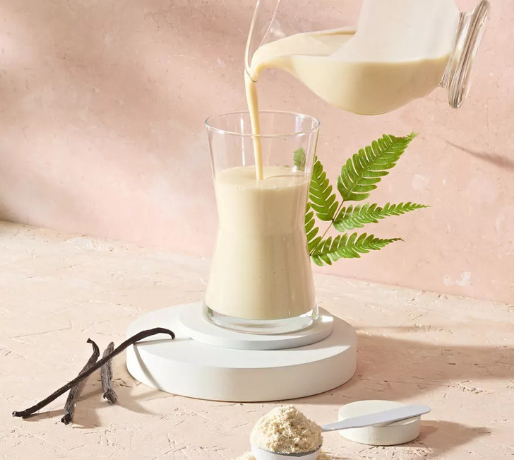 Herbalife Vegan Protein Drink Mix (Vanilla) 7 x 28g Sachets in a glass with a straw.