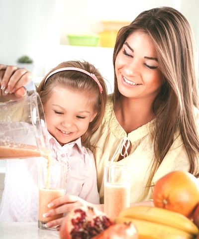 Photo depicting a Mother and Daughter pouring a Herbalife Formula 1 Nutritional Shake Mix