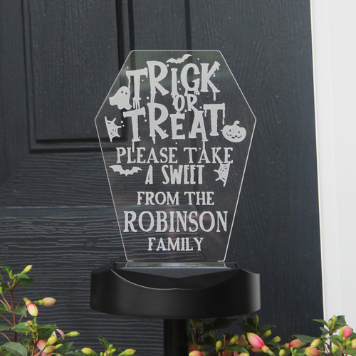 This spooky personalised Trick or Treat solar light is the ideal Halloween decoration!

Perfect for indoor or outdoor use to let the Trick or Treaters know you have sweeties!

The light can be personalised with any message over 3 lines, each containing up to 12 characters per line.
Please note that the text entered will appear in upper case.

'Trick or Treat. Please take a sweet.' is fixed text and cannot be changed.

Sign - Height 19cm / Width 13.5 cm / Depth 0.3 cm
Ground stick and solar panel base - Height 34cm / Width 14 cm / Depth 9 cm

Installation (2 options)
A. Connect the solar lamp base to the ground rod, and push into the ground/pot where you would like it.
B. Drill two holes on the wall, insert the screws and hang up the solar light. (Screws included)

Peel off the protective film from the solar panel. Press and hold the button for 5 seconds on the bottom of the LED light to turn it on (note - cover the solar panel with your hand to test if it is on. Please note the item will not solar charge if it is not turned on.

No batteries or wires required, just ensure the solar panel light is placed in a sunny light environment.

Short press the button to change the colour mode and light mode. The colour and light modes are below.
White, red, green, blue, orange, light blue, purple, flashing, strobe, fading and smooth.

Ideal for Halloween
